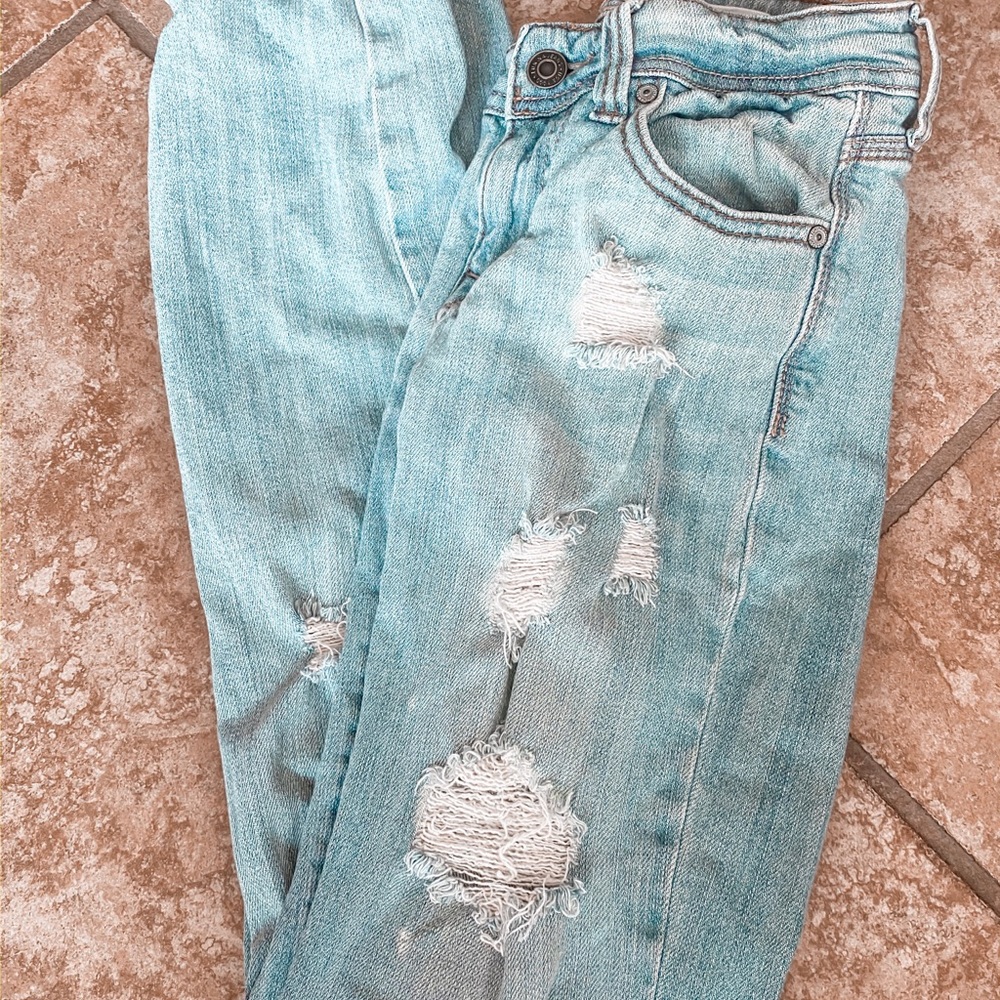 destroyed denim mid rise light blue jeans
